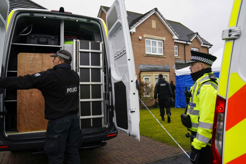 Police officers unloading a van outside Nicola Sturgeon and Peter Murrell's home.