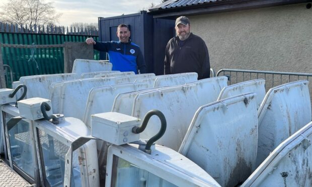 Martin Glen and Kinnoull groundsman Kevin Graham with floodlights which have been recycled from the redevelopment of Perth High School.