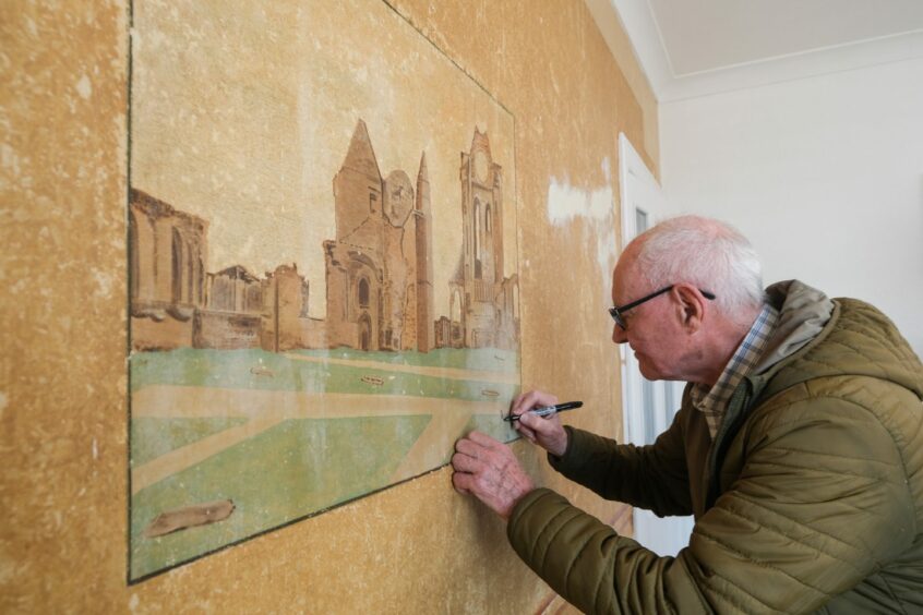 John adds his signature to his late father's Arbroath Abbey painting.