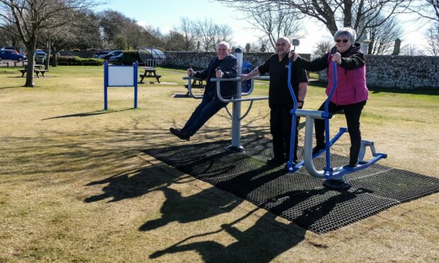 Community council vice-chairman George Aitken, KRG chairman Ron Lobban and KRG treasurer Irena get into the swing of the new equipment. Image: Paul Reid