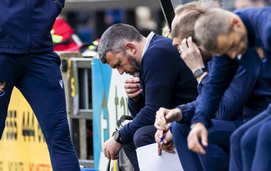 Callum Davidson in the dugout with head bowed