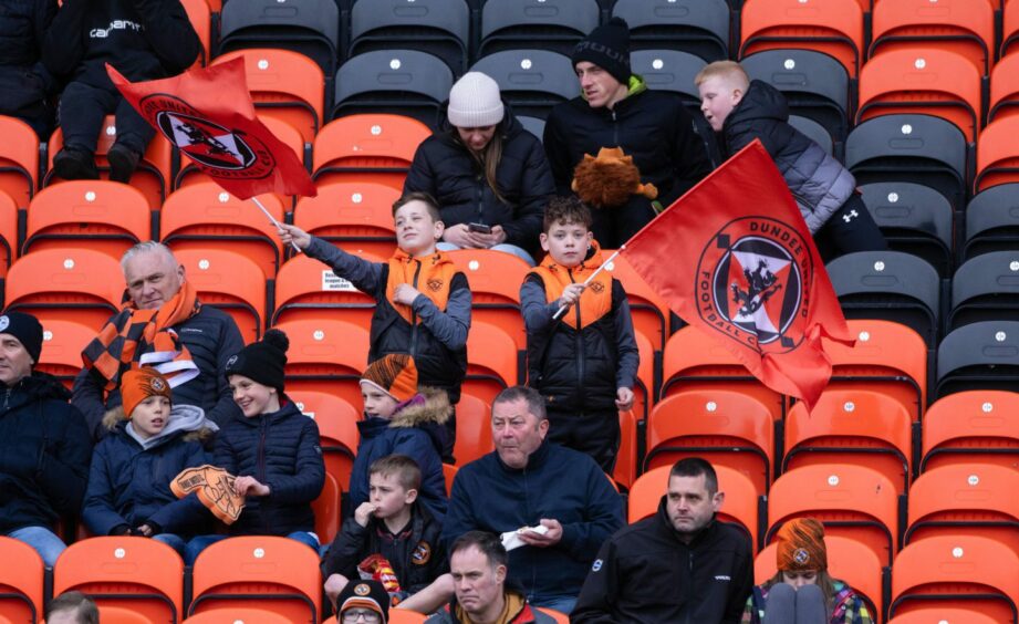 Couple of Dundee United fans fly the flags at Tannadice.