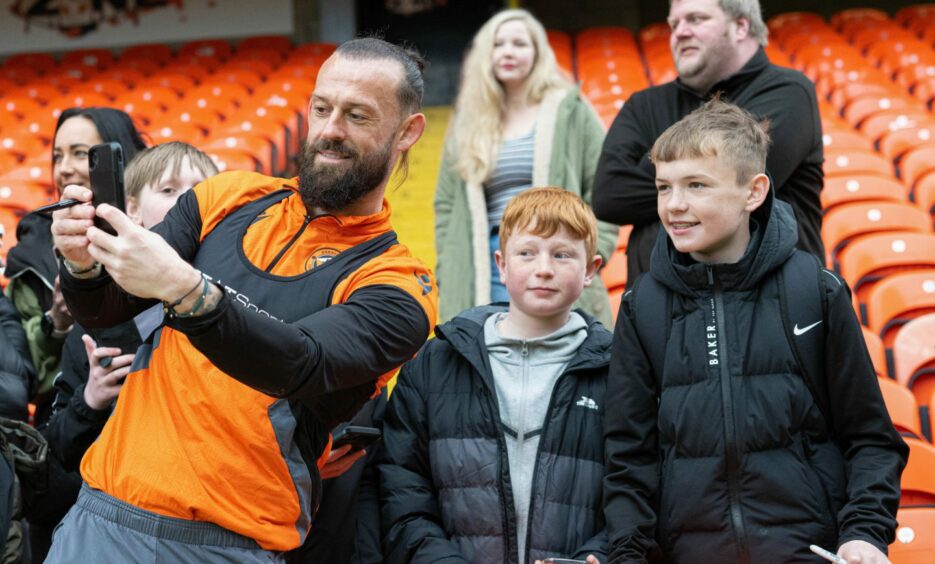 Star striker Steven Fletcher takes a selfie with young fans.