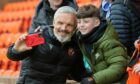 Jim Goodwin takes a selfie with a young Dundee United fan.