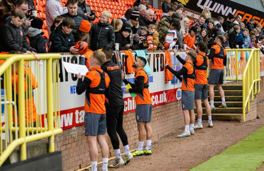 Dundee United stars sign memorabilia for supporters at Tannadice.