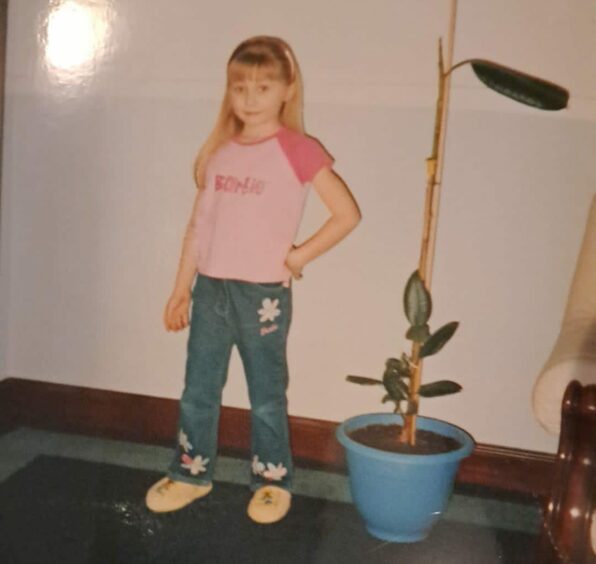 Rebecca Baird as a child in Barbie t shirt