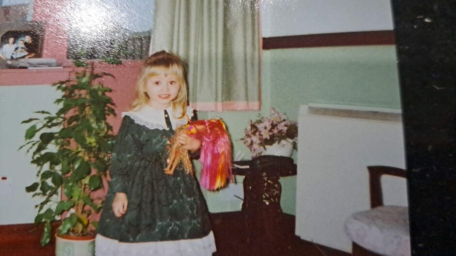 Rebecca Baird with Barbie doll as a toddler