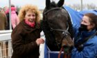 Lucinda Russell (left) celebrates in the parade ring with Mighty Thunder after the 2021 Scottish Grand National.