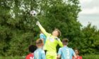 Dundee U/16s goalkeeper Ally Graham (yellow) in action.