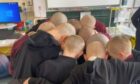A sea of bald heads at Markinch Primary School when Archie visited after his first treatment session. Image: supplied.