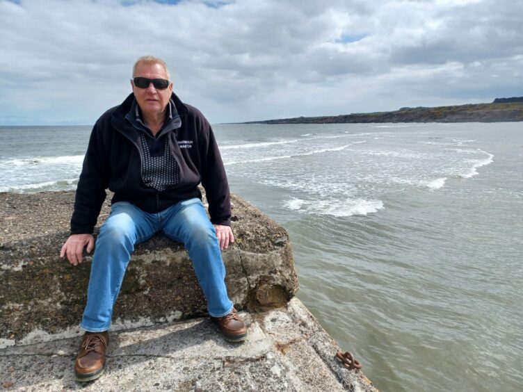 St Andrews Harbourmaster John Lambert at the end of St Andrews Harbour's main pier.