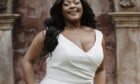 Model wearing a plus size boho wedding dress by Innate Curves.
