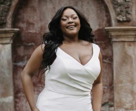 Model wearing a plus size boho wedding dress by Innate Curves.