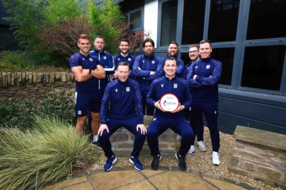 Dundee manager Gary Bowyer wins Glen's Championship Manager of the Month for March and club staff. Back (from left): Macauley Kenney (sports scientist), Alan Combe (goalkeeping coach), Bruce Smith (physio), Scott Paterson (coach), James Morrison (equipment manager), Tommy Young (operations coordinator), Matty Castle (performance analyst). Front: Billy Barr (assistant manager), Gary Bowyer (manager). Image: SPFL.
