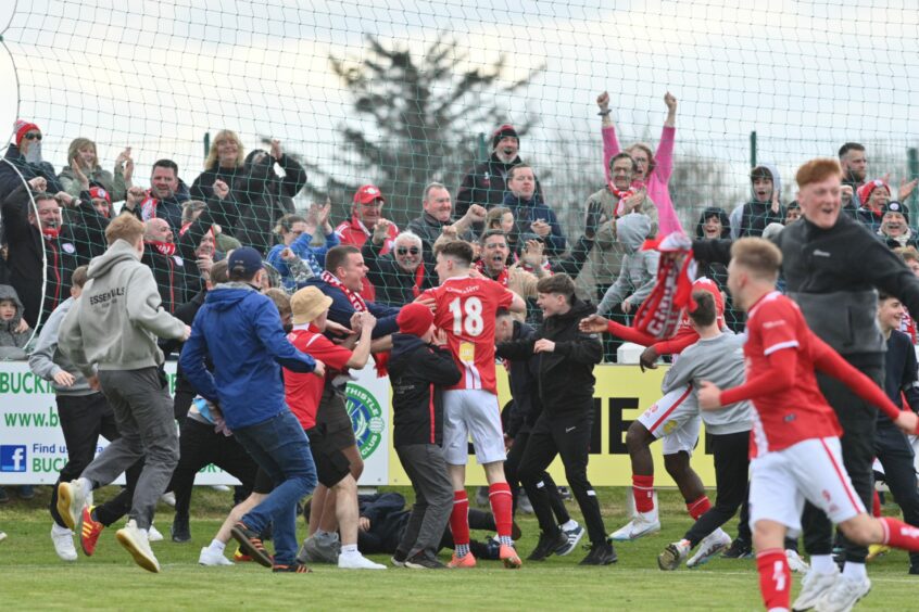 Jason Hedges in 18 shirt mobbed by fans on the pitch after Brechin's first goal