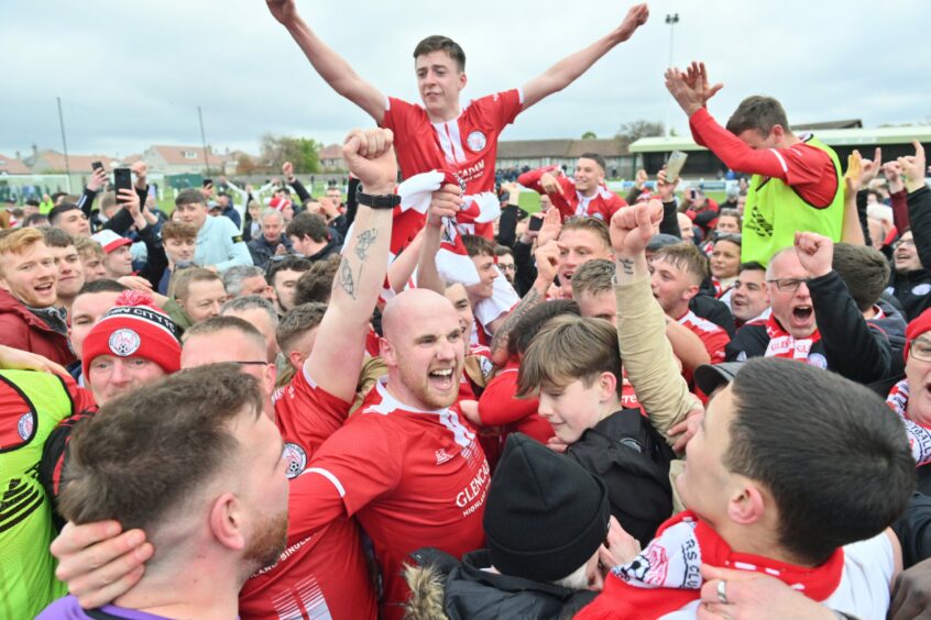 Brechin City stars celebrate with fans on the park after their Buckie Thistle title win. Image: Jason Hedges / DCT Media.