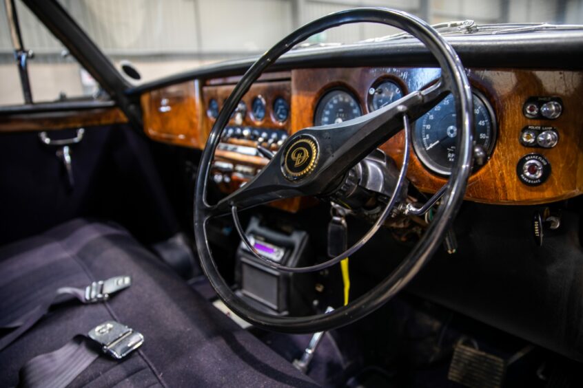 Behind the wheel of the Daimler limo used by the Queen Mother.