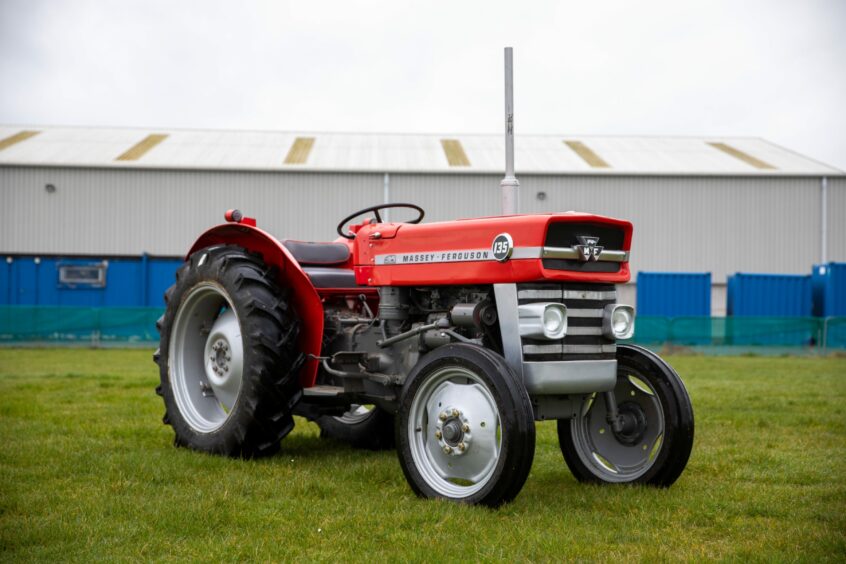 A restored red Massey Ferguson tractor is on sale at the auction.