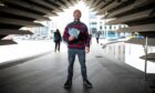 Mark Richardson with copies of his new book, outside the V&A, Riverside Esplanade, Dundee. Image: Kim Cessford / DC Thomson