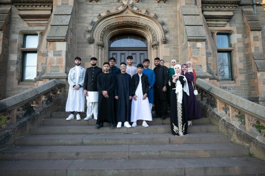 S5 and S6 pupils who organised the Iftar party gathered for a snap at the entrance to the academy.