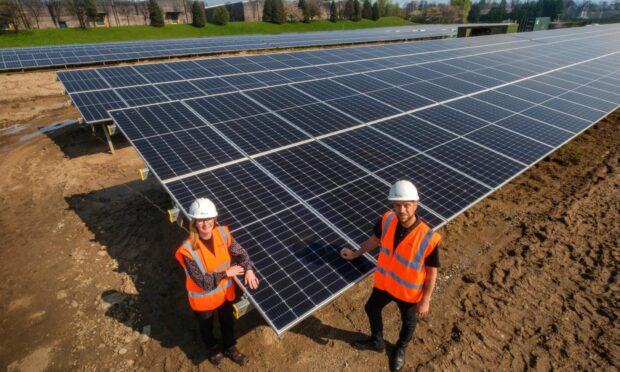 Kerry Easter and Jay Christie of Diageo at the Leven solar array. Image: Diageo.