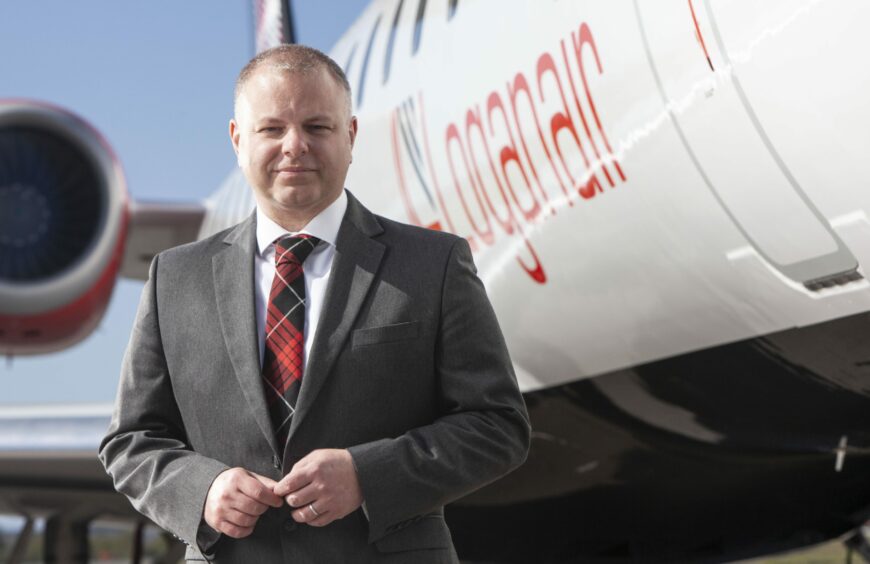 Jonathan Hinkles, chief executive of Loganair, in front of one of the company's aircraft