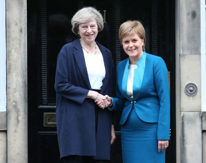 Nicola Sturgeon and Theresa May shaking hands on the steps of Bute House.