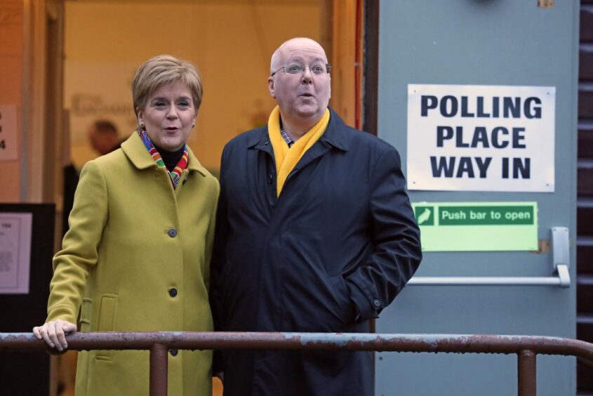 Nicola Sturgeon with husband Peter Murrell outside a polling place.