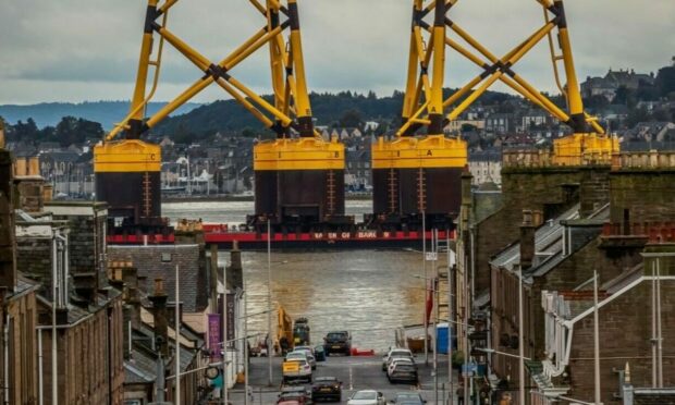 A barge shipping turbine jacket foundations for installation at Seagreen passing Broughty Ferry. 
Image: Ken le Grice/Seagreen Wind Energy.