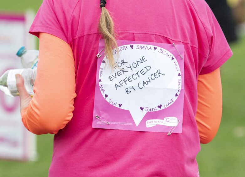 Woman about to do Race for Life wearing a t-shirt that says 'for everyone affected by cancer'