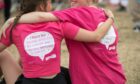 Two runners sat hugging after running Race for Life in Dundee.