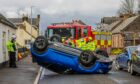 The car on its roof. Image: Steve MacDougall/DC Thomson