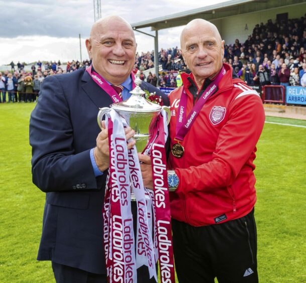 Dick Campbell and brother Ian with the League One title trophy after winning it with Arbroath. Image: SNS