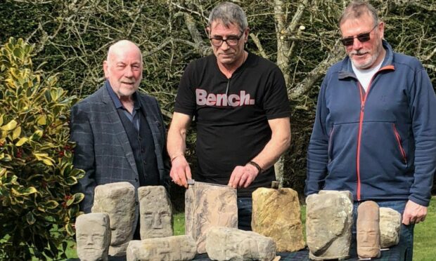 Dave Ramsay, Brian Wylie and Dave Clark with the collection of recently acquired Adam Christie stones. Image: Montrose Burns Club