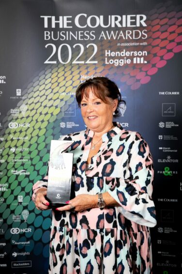 Tony Banks' sister Terry collects Courier Business Award on his behalf.