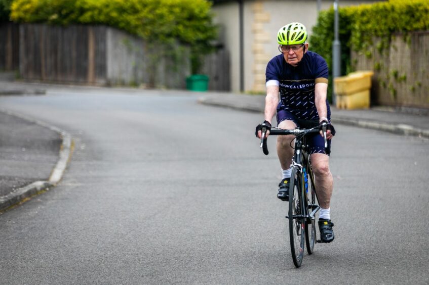 Cupar cyclist John McNally riding his bike with an Etape Caledonia vest. 