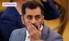 Humza Yousaf holding his hand over his mouth.