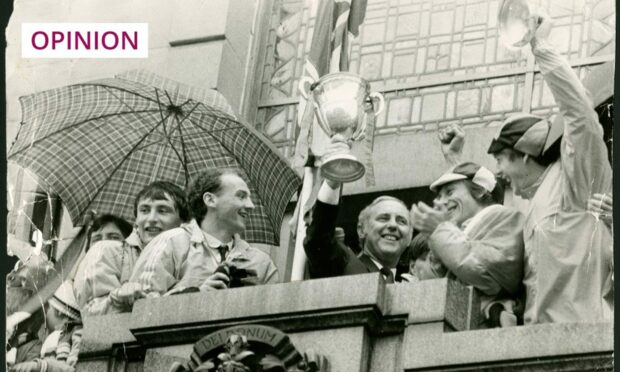 black and white photo of Jim McLean and players with the league cup in Dundee City Square in 1983