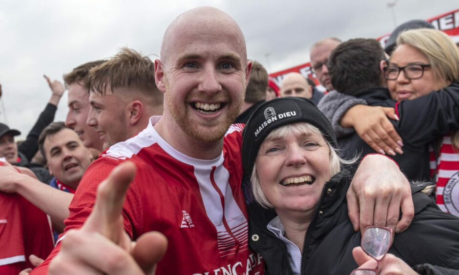 Euan Spark celebrates his Highland League title success with mum Isobel.