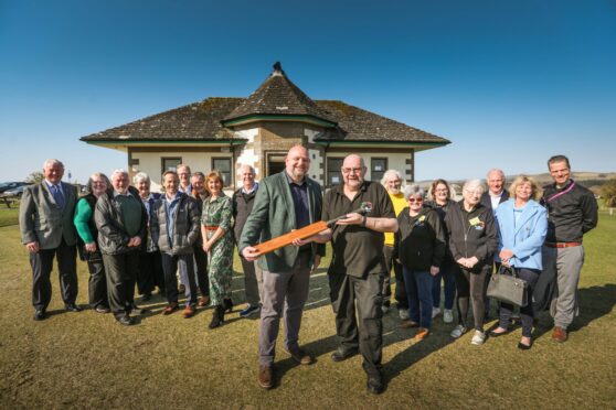 Iain Harkins of the National Trust for Scotland and Kirrie Regeneration Group chairman Ron Lobban surrounded by Lowson family members and KRG volunteers. Image: Mhairi Edwards/DC Thomson