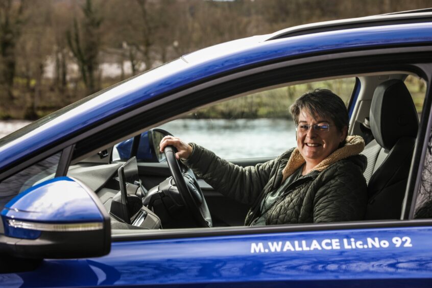 Marian Wallace in her electric taxi.