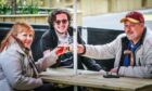 Karen, Eoin and Colin Smith enjoy a pint outside at the Bank Bar. Image: Mhairi Edwards/DC Thomson.