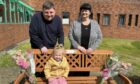Shannon's daughter Abbie, 3, sits on her mum's memorial bench with dad Jordan Burt and Shannon's mum Tracy. Image: Supplied by Jonathan Watson