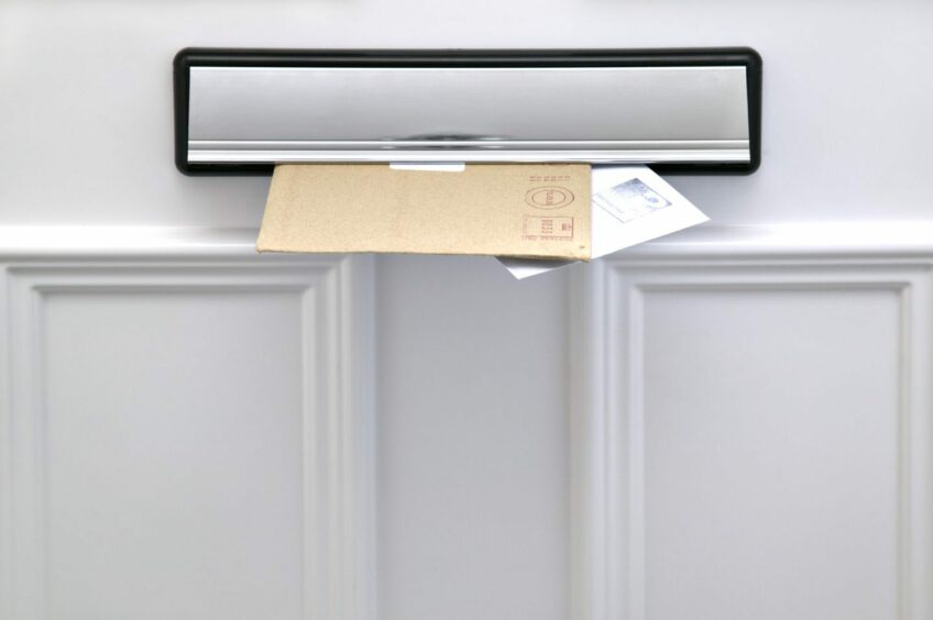 two enveloped poking through a letter box
