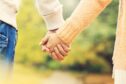 Couple holding hands as they plan date ideas in Fife