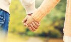 Couple holding hands as they plan date ideas in Fife