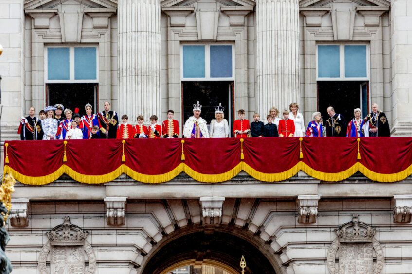 King Charles III and Queen Camilla with family members on the Buckingham Palace balcony following the coronation.