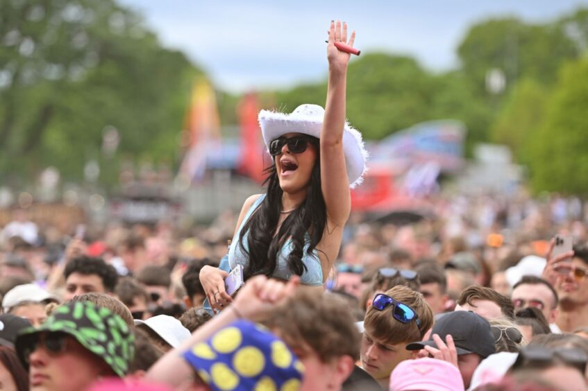 A reveller is held aloft during the ArrDee performance. 