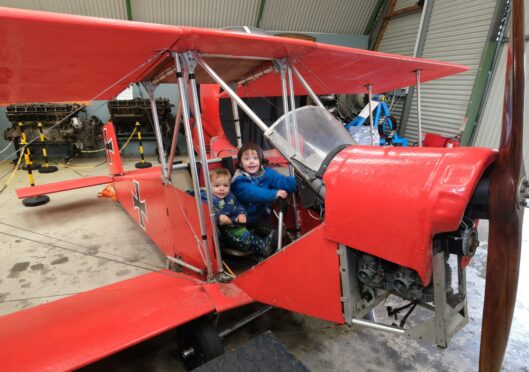 One-year-old Cairn Lynch and brother Darra, 3, in the centre's Red Baron replica. Image: Paul Reid