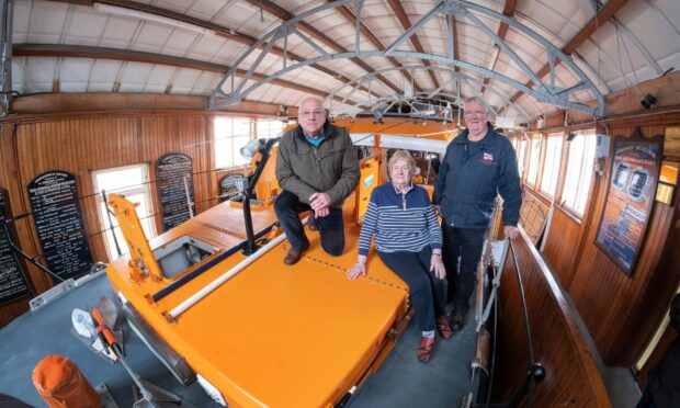 Arbroath lifeboat figures Ian Ballantyne (left), Mo Morrison and Alex Smith on the RNLB Inchcape in the town station. Image: Paul Reid